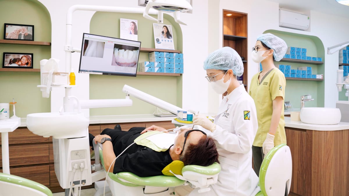 Dentist performing precision dental treatment with digital screen showing teeth at Picasso Dental Clinic Hanoi